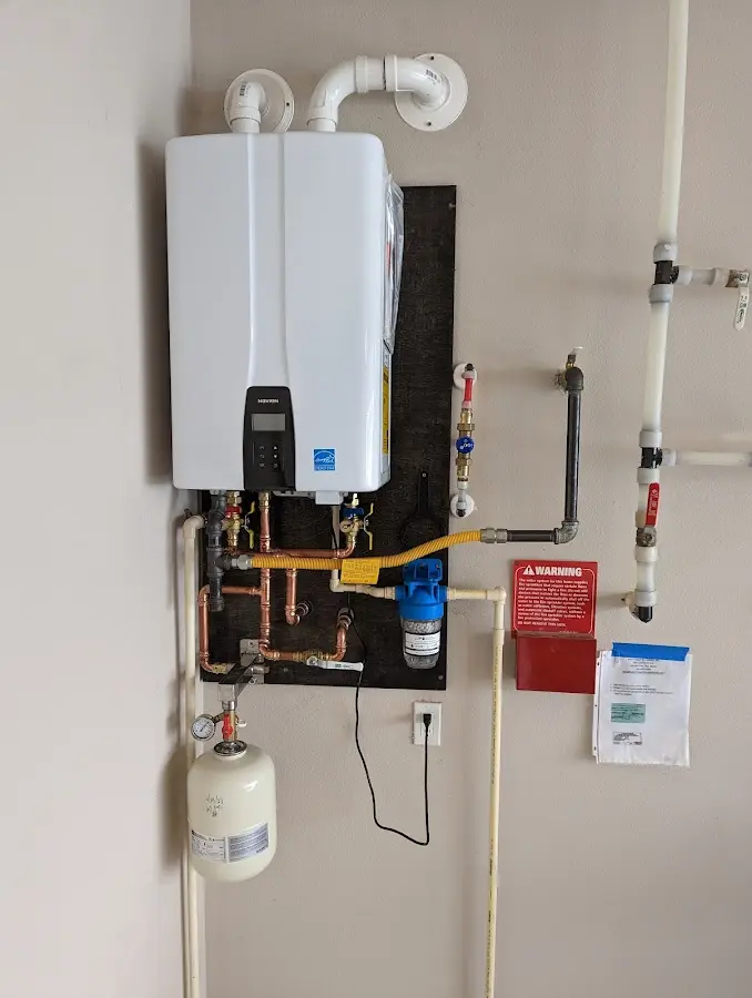 Professional plumber installing copper piping in a Rockdale home